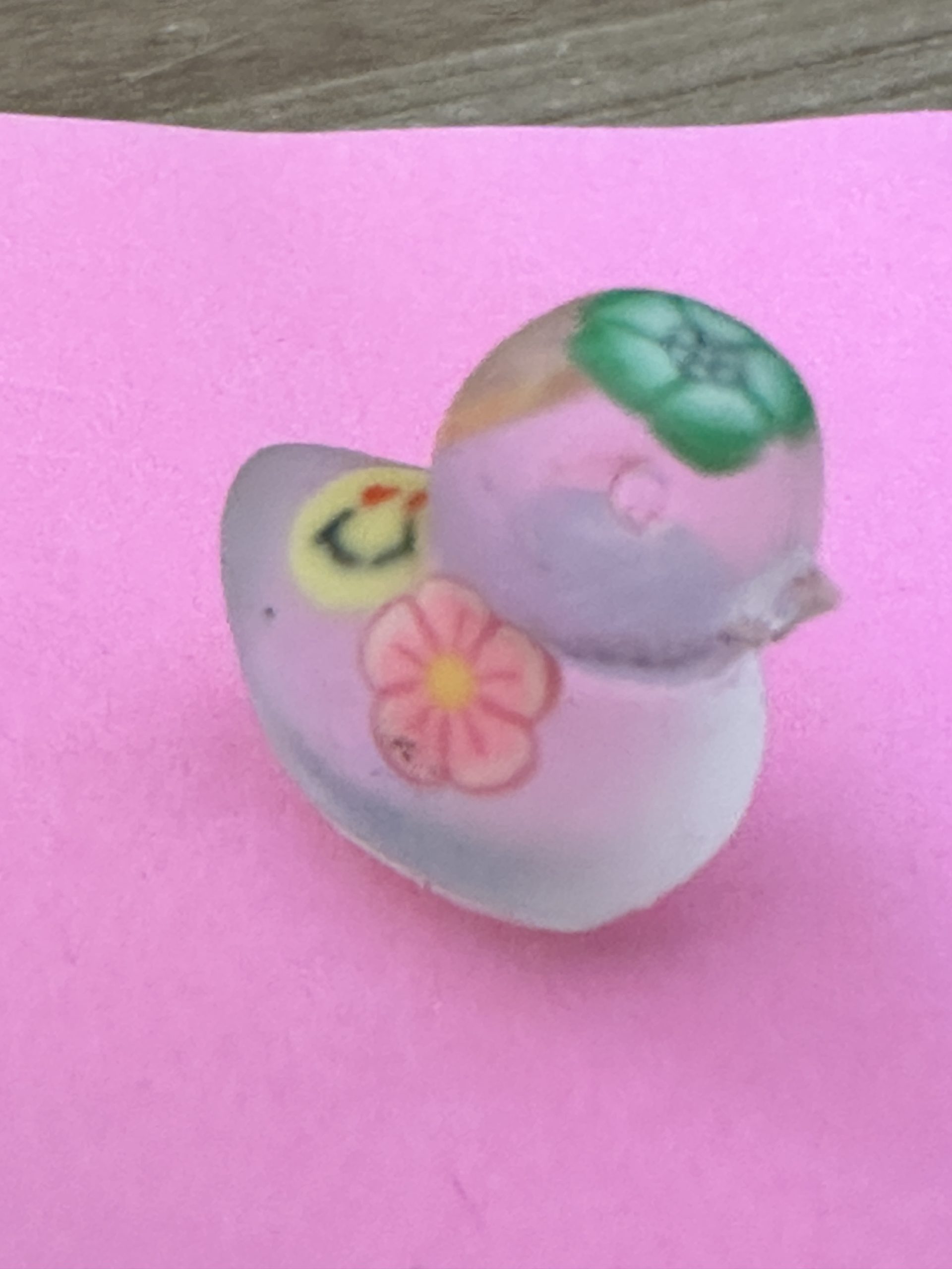 Cute miniature duckling in clear resin with “hippy” flowers embedded, like one does.